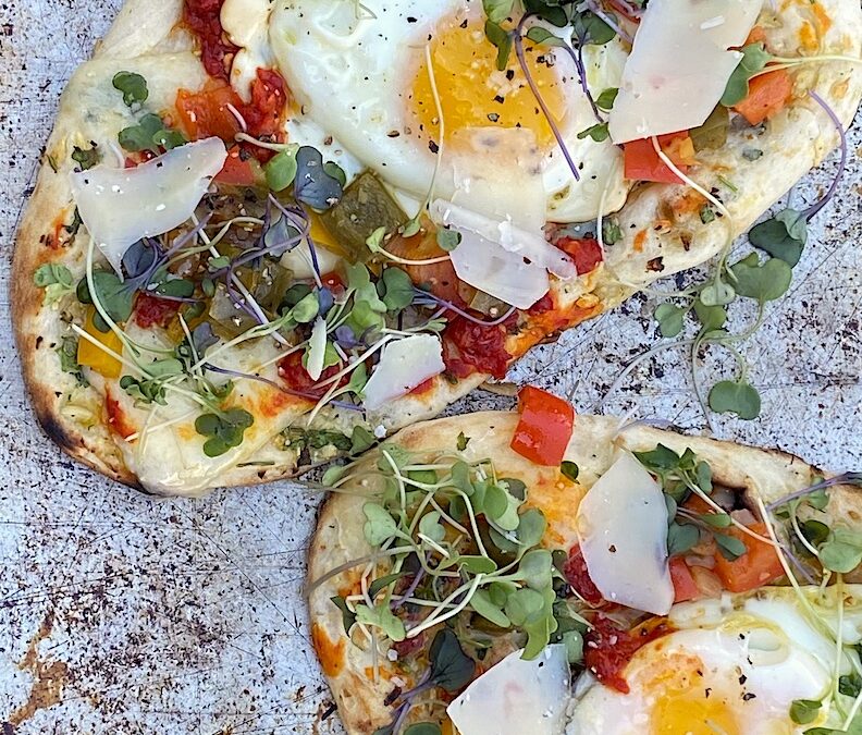 FRIED EGG FLATBREAD with SHARP CHEDDAR, ROASTED RED PEPPER SPREAD & MICRO GREENS