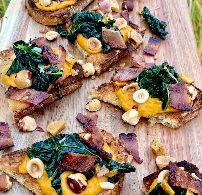 MAPLE-BOURBON WHIPPED BUTTERNUT & GARLICKY KALE TOAST with HAZELNUTS & BACON